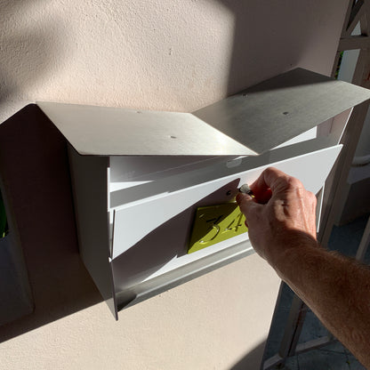 Wall Mount Mailbox mounted to outdoor wall. ButterFly Box in arctic white and lemon lime